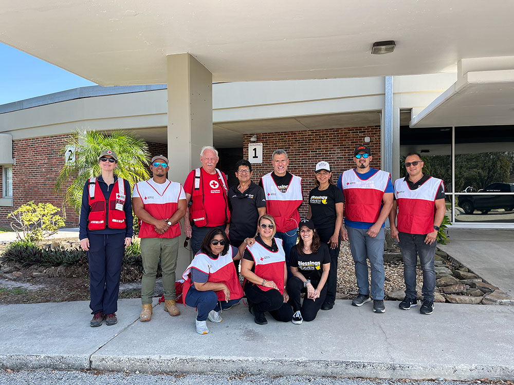 Group photo of Red Cross volunteers and Blessings from Heaven Foundation Damage Assesment Team in front of a building.