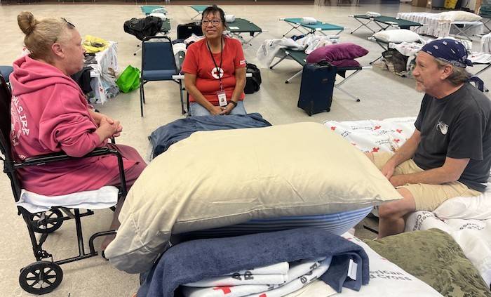 Red Cross clients Brian and Nanza Darley talking with Red Cross volunteer Angie Irmer.