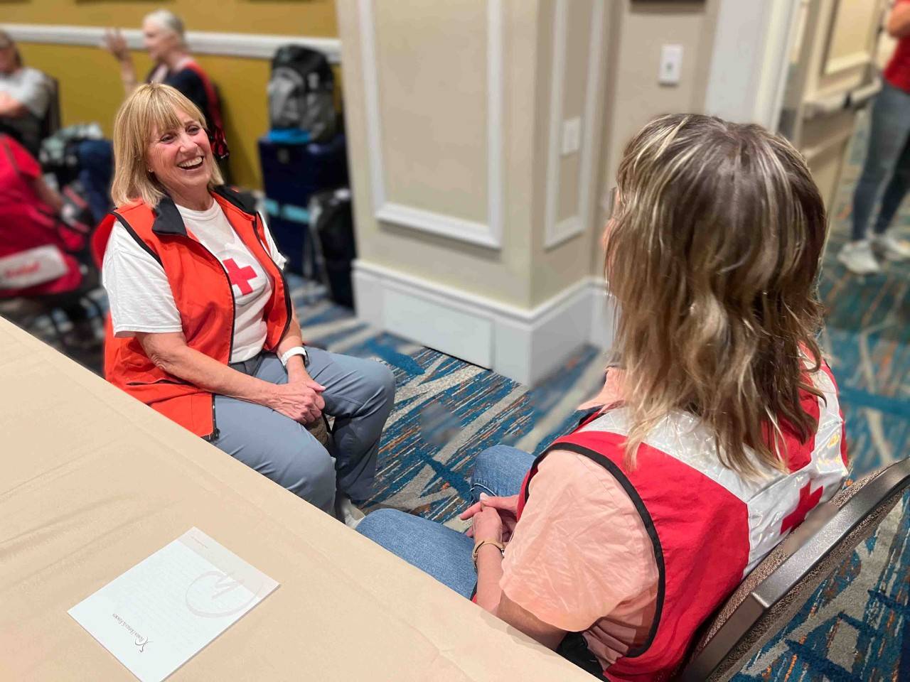 Volunteer Debbie Rohatsch chats with volunteer Stephanie Gilstrom