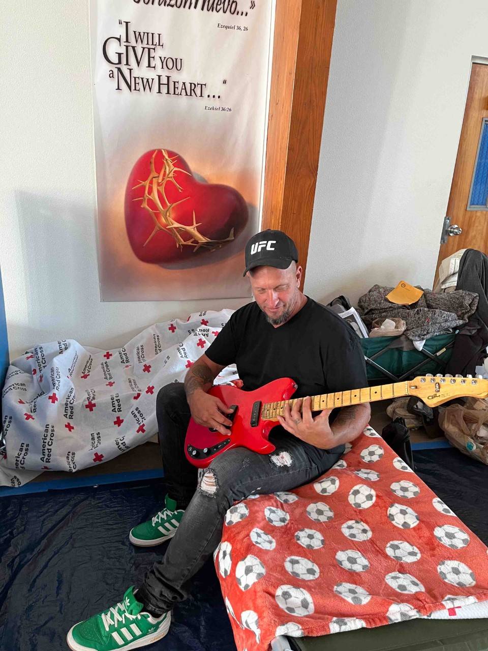 Adam Freed with holding a guitar.