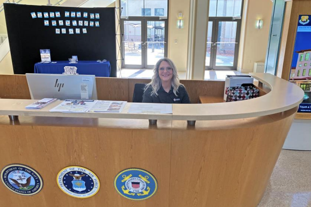 Volunteer Julie Morris sits behind a desk