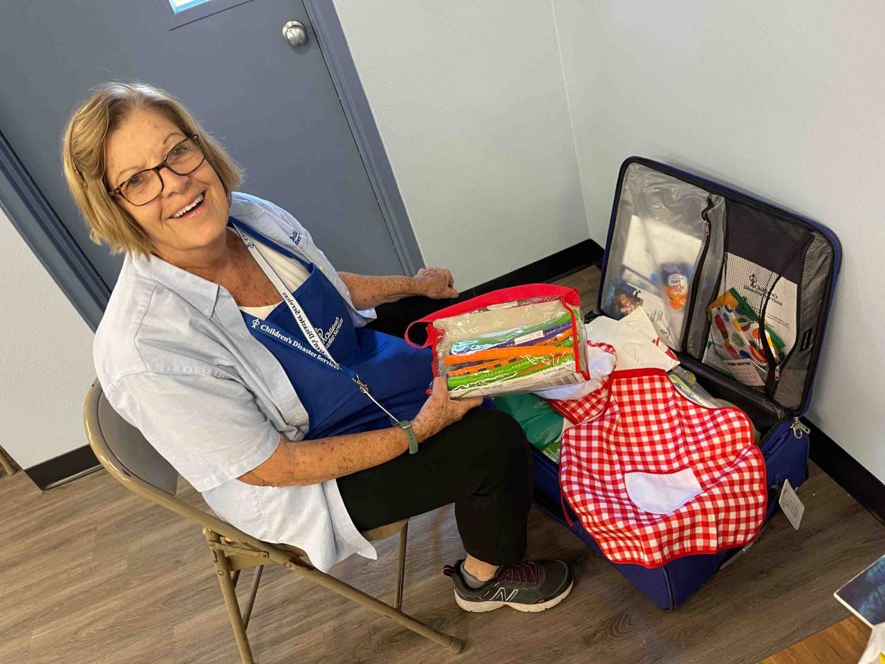 Volunteer Linda shows her “Kit of Comfort” for the camera. 