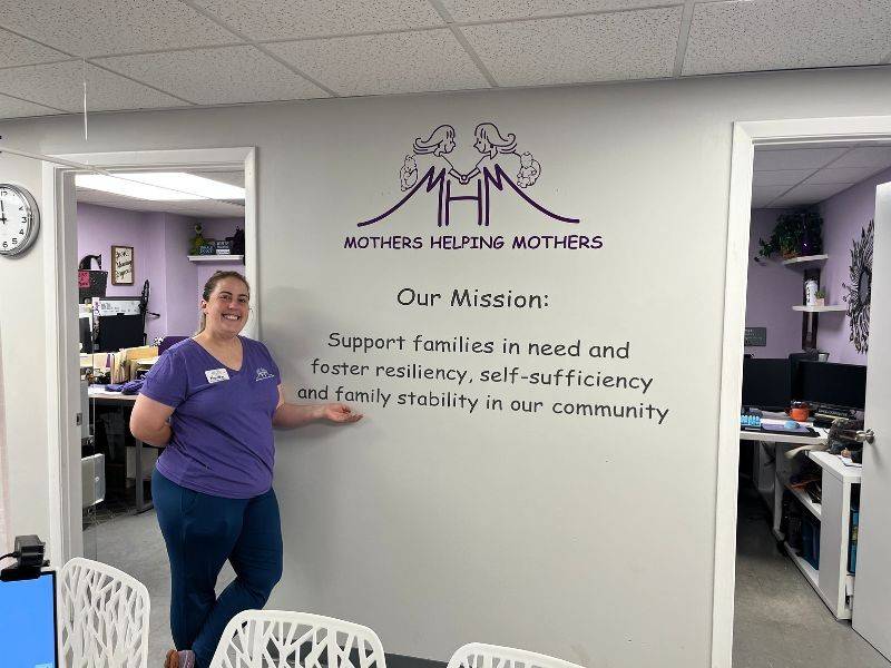 martha brookley standing in front of quote on wall
