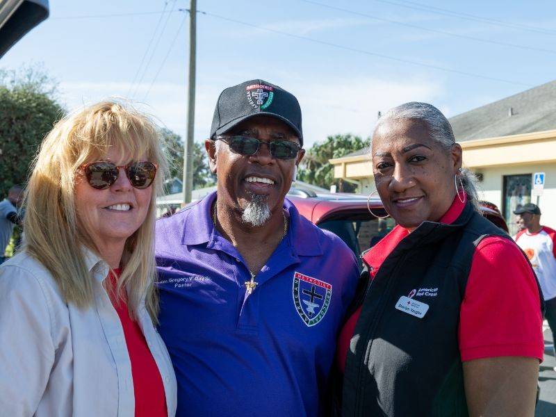 man and two women volunteers posing for camera