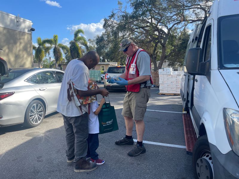 Sarasota resident and child receiving water