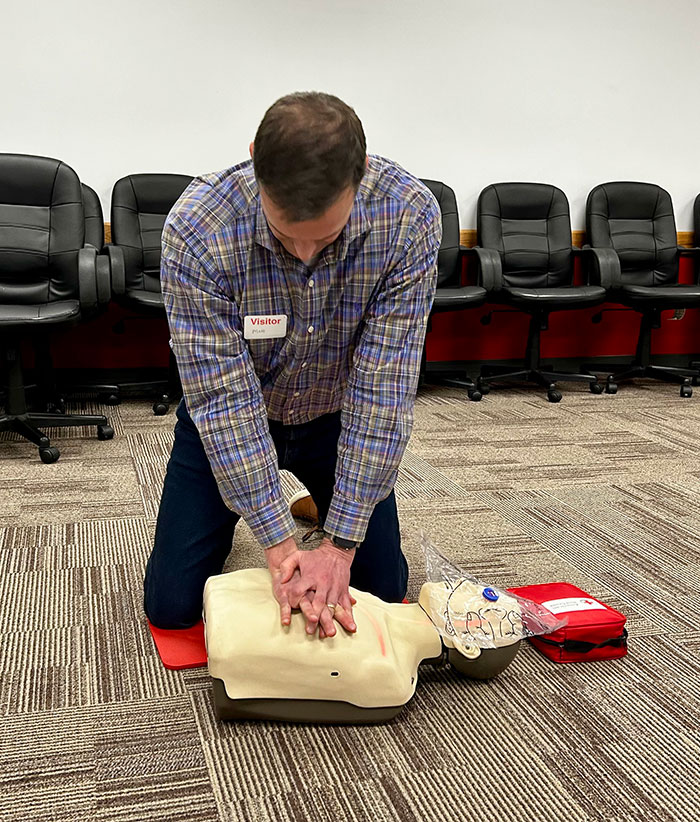 A Red Cross Central Ohio Board member praticing CPR on a manikin.