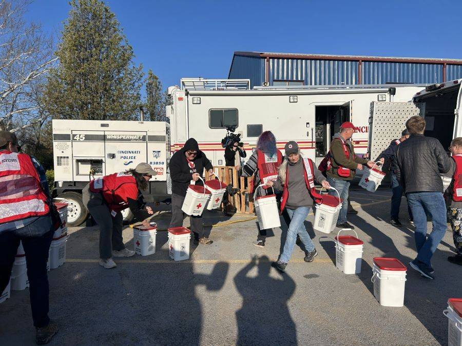 A group of people adding items to serveral buckets