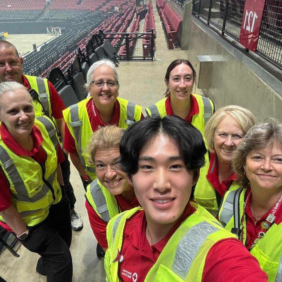 Debbie and a group of volunteers in a stadium 