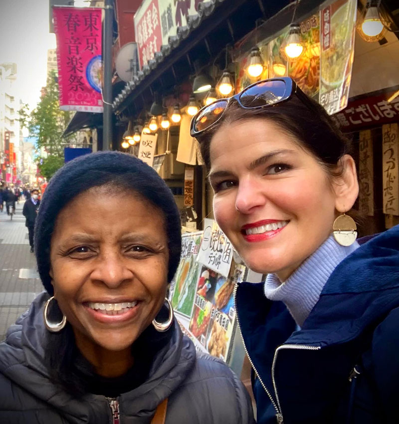 Janice Winston and Emily Fortman walking in the city wearing jackets.