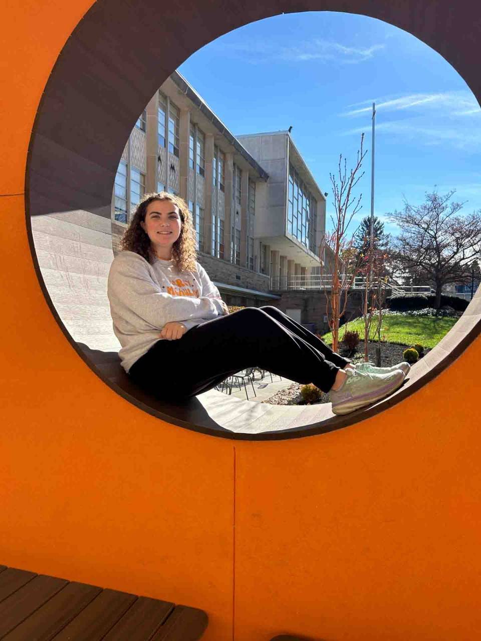 Mercy McAuley High School student Kat Bowman sits inside circle.