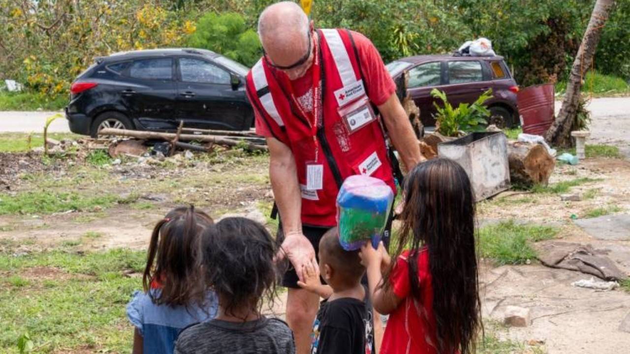disaster volunteer with children in guam