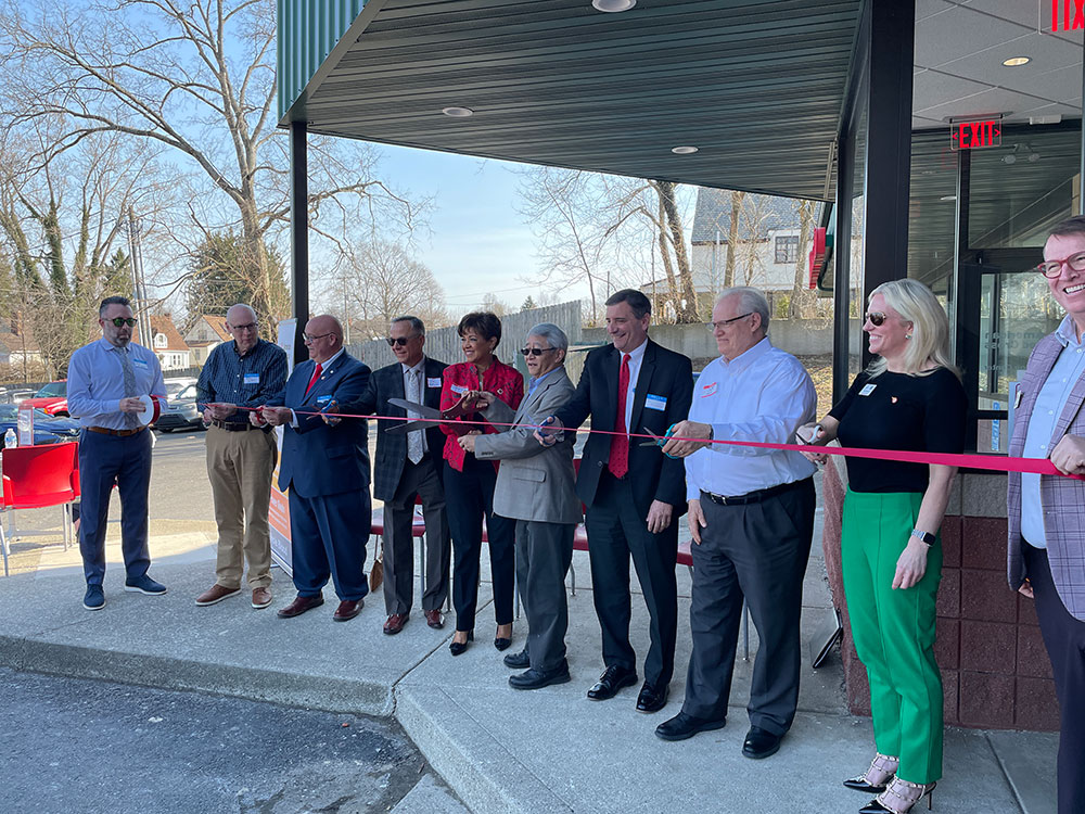 multiple people ready to cut the ribbon at the ribbon cutting ceremony for the Red Cross Blood and Platelet Donation Center.