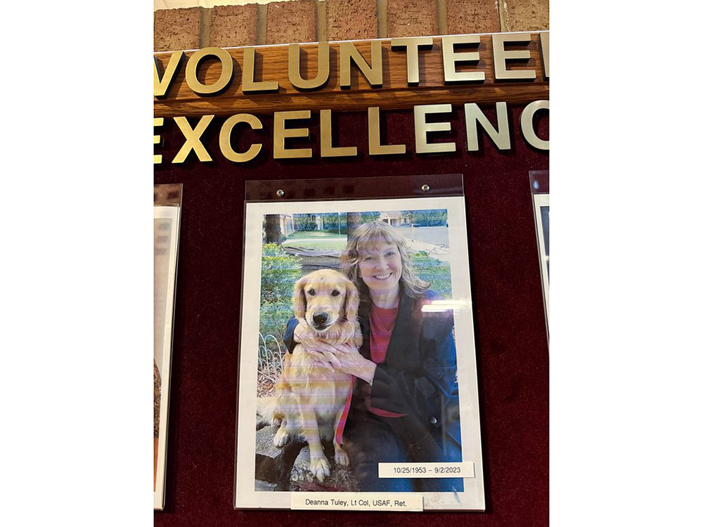 picture of Lt. Colonel Deanna Tuley with her dog, hanging on a wall.
