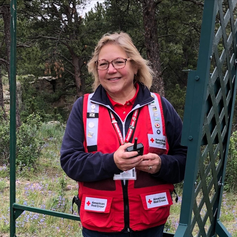 Thea Wasche wearing glasses and Red Cross vest.