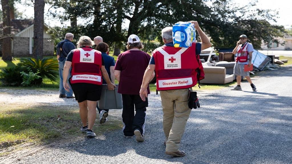 September 26, 2019. Hamshire, Texas. DES (distribution of emergency  supplies) volunteers deliver cleaning supplies and water to a flooded home In Hamshire, Texas.  Homeowners Harold and Norma Lambert narrowly got out of the house as the storm got progressively worse. "We had to try four different routes before we found a way to safety," said Lambert. Photo by Heather Fairchild/American Red Cross