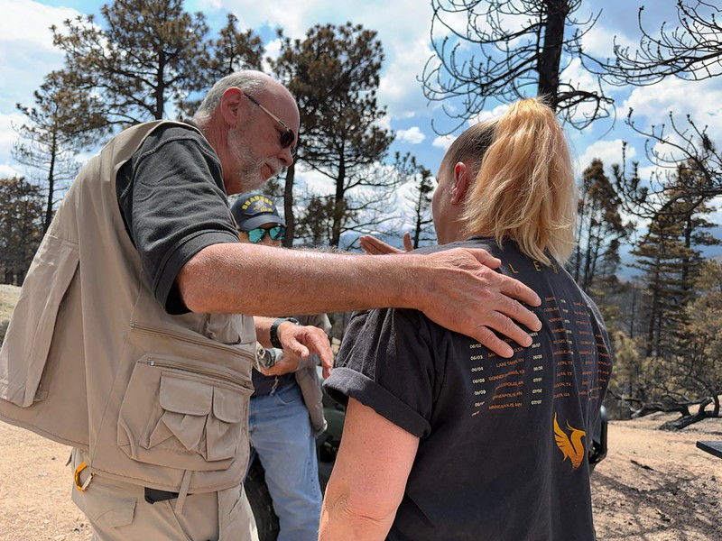 A Red Cross volunteer comforts a woman