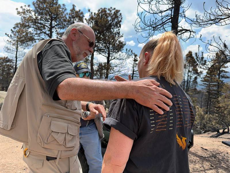 A Red Cross volunteer comforts a woman