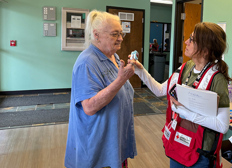 A woman takes another woman's pulse and blood oxygen levels