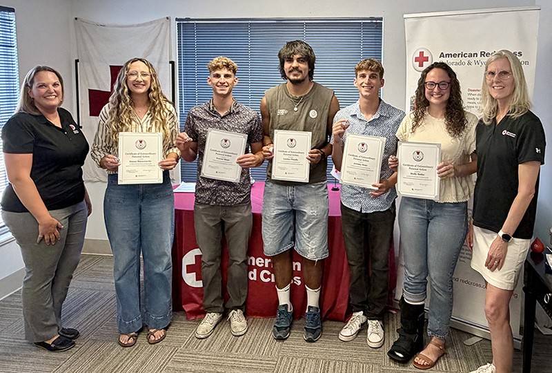 A group of people standing together, holding awards and smiling