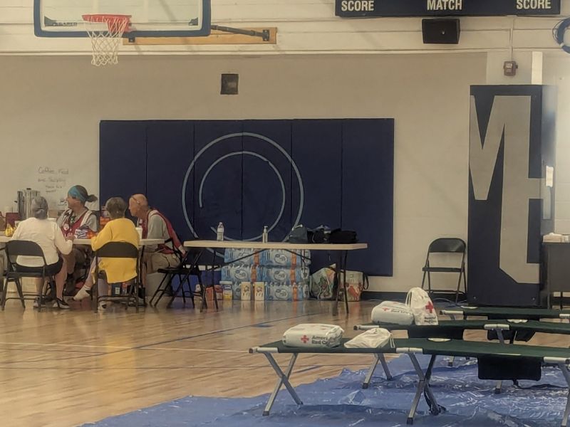 volunteers sitting at table inside shelter
