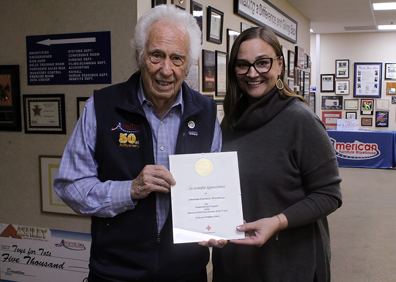 Two people standing with a plaque