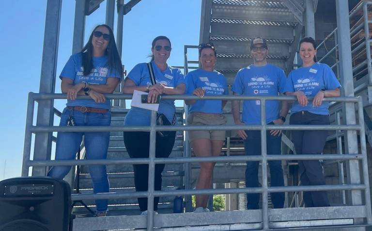 Several people stand on a platform