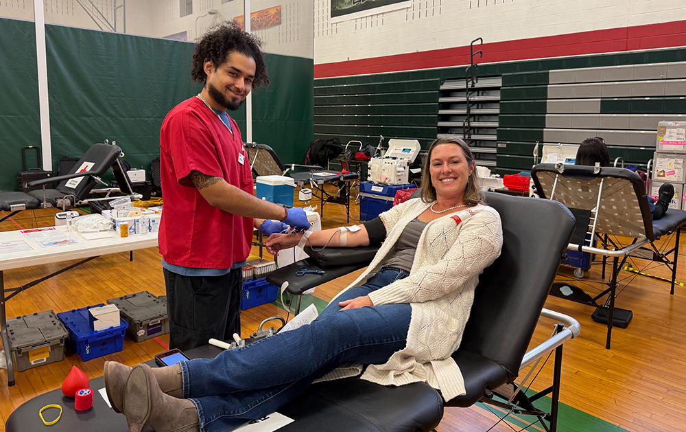 A woman, smiling, during a blood donation