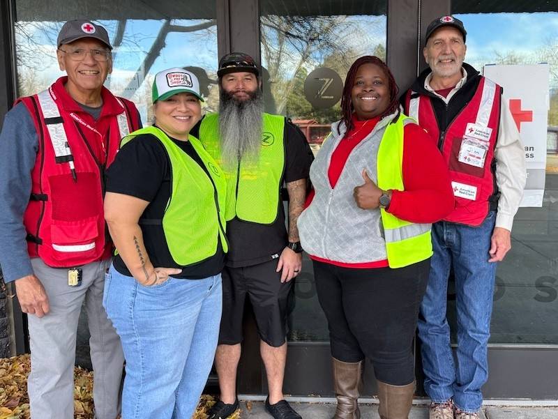 Red Cross volunteers stand in front of Zeal Church
