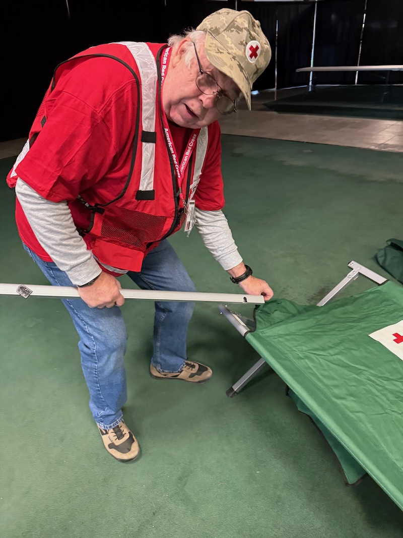 Man assembling a cot