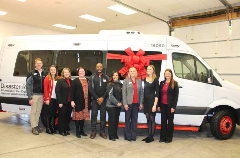 Dakotas Region staff are photographed in front of new ERV 