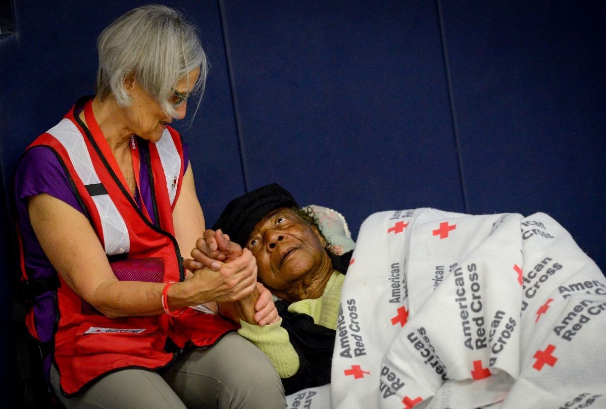 A Red Cross volunteer comforts a person affected by Hurricane Florence