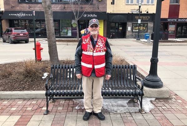 Jerry Walker stands in Downtown Fargo wearing his Red Cross vest.