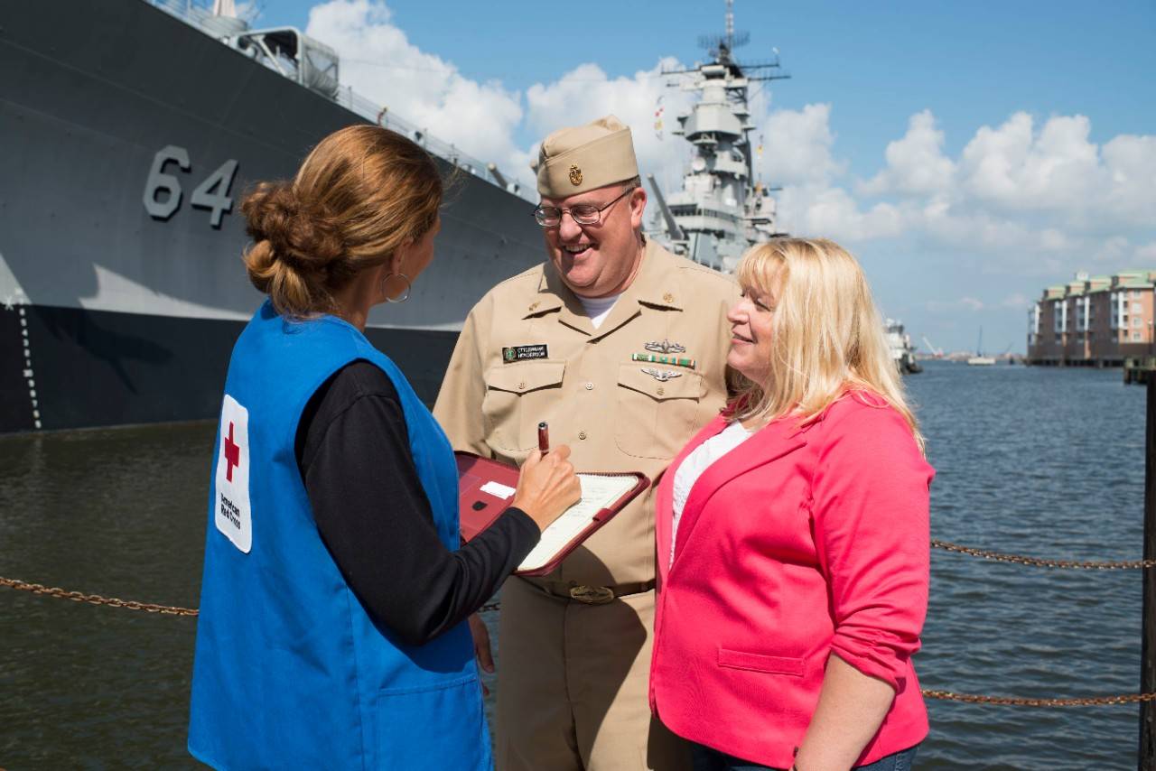 July 26, 2013. Norfolk, Virginia. US Navy service member and wife in Norfolk, Virginia with Red Cross worker Theresa Soska. Photo by Mike Murdock/American Red Cross