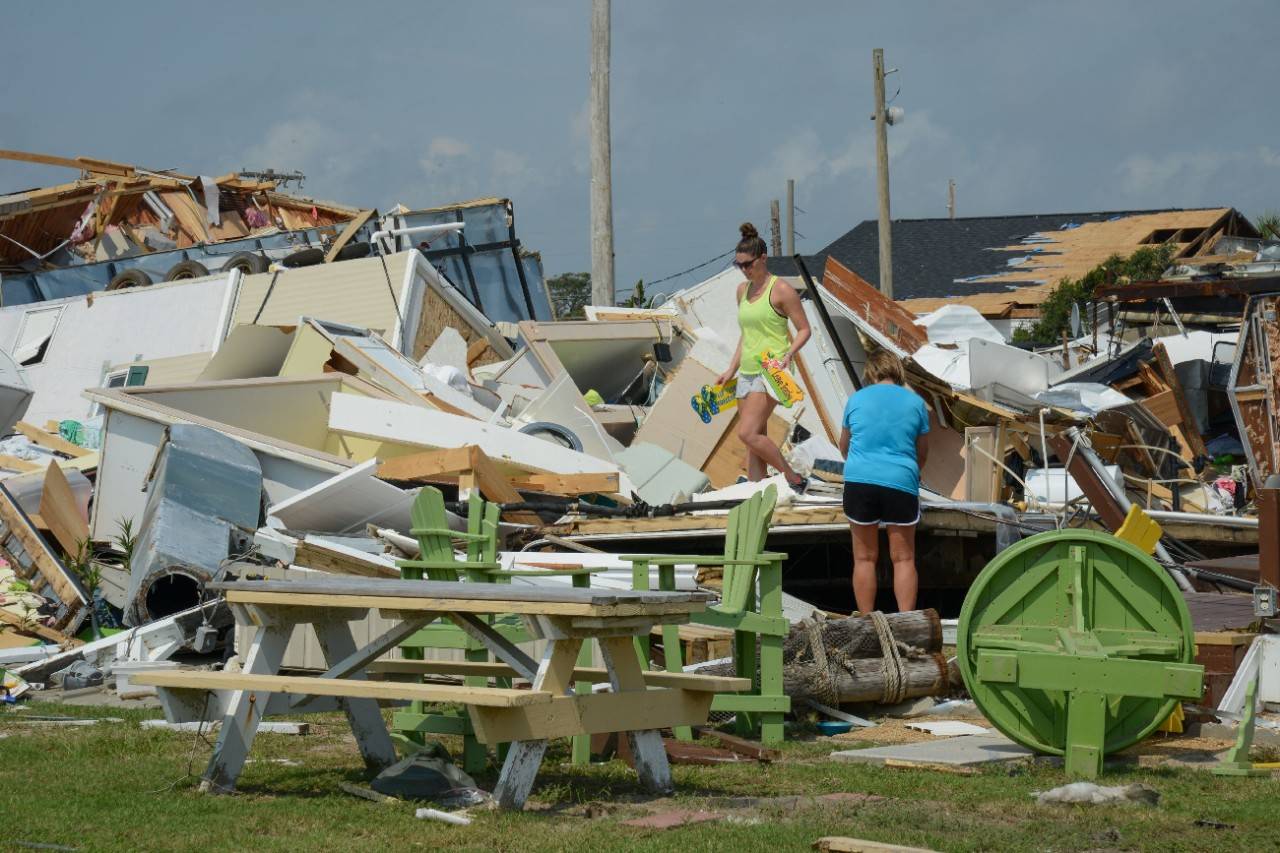 Emerald Isle, North Carolina, September 8, 2019. Denise and Lindsay Alford search through the wreckage of a home for personal items that can be salvaged at the Boardwalk RV park on Emerald Isle, North Carolina. The home was destroyed on September 5 when a waterspout, traveling on the front edge of Hurricane Dorian, tore through the park, destroying many of the RV get-away homes. Amazingly, none of the residents were injured as almost all of evacuated the area as the hurricane approached. Photo Credit: Daniel Cima/American Red Cross