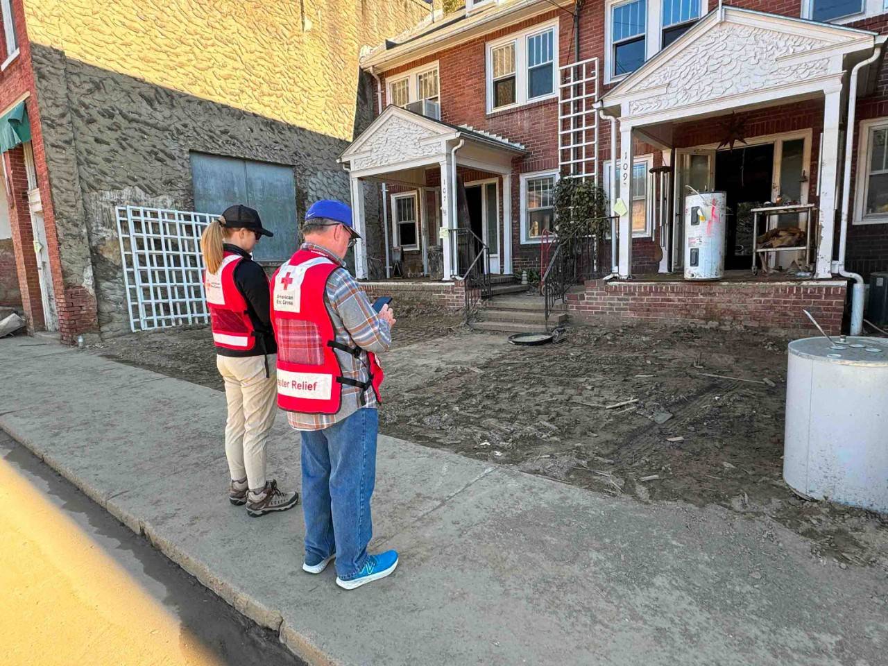 American Red Cross volunteers assess damage to a house