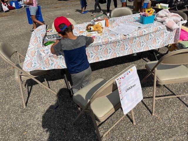 Kid coloring at spruce pine event  