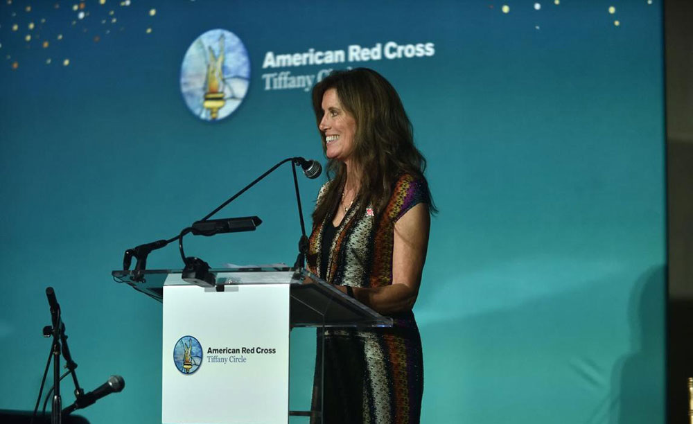 Susie Trotochaud speaking at a podium at the 2025 Tiffany Circle Summit.