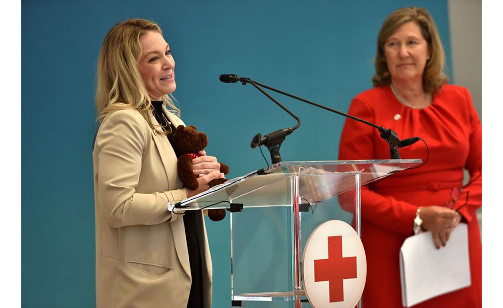 Caroline Weeks, board member of the Red Cross Greater Atlanta Chapter, speaking at a podium.