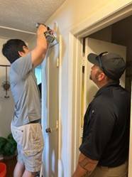 Erin Yoo installing smoke alarms