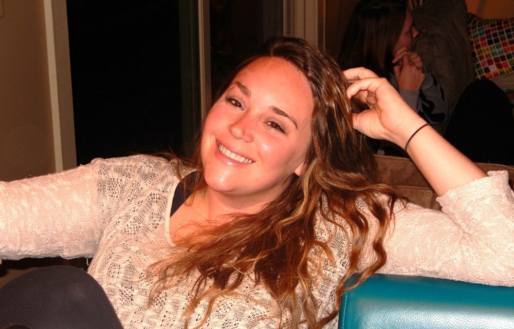 Elizabeth Gill's daughter Rachel Thorn sitting and smiling for picture.