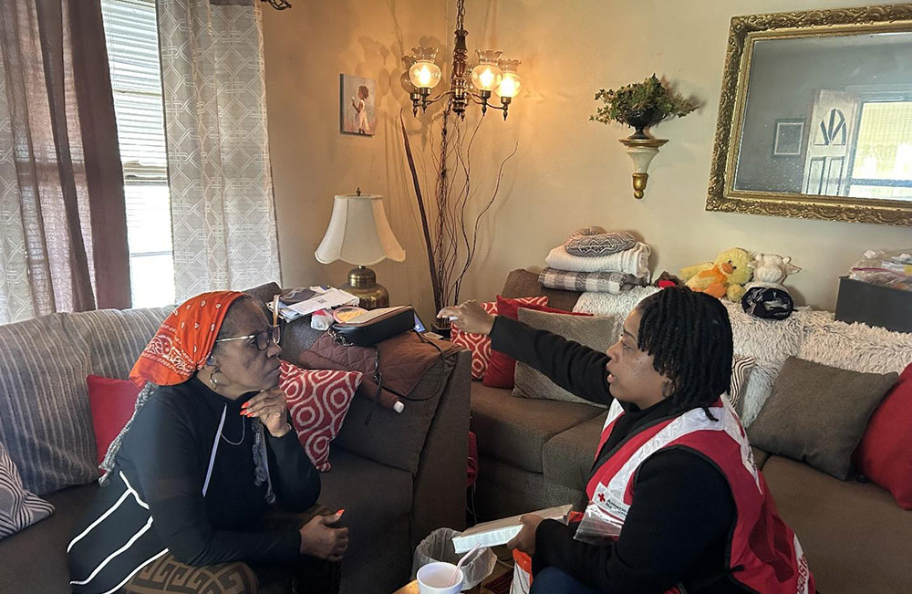 Homeowner Ethel Tyson reading the lips of Red Cross Community Disaster Program Manager Mikkita Dean.