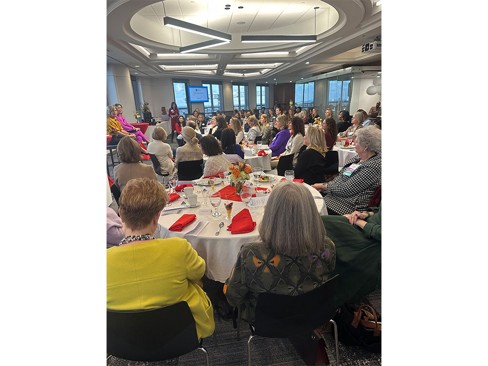 people seated at tables listening