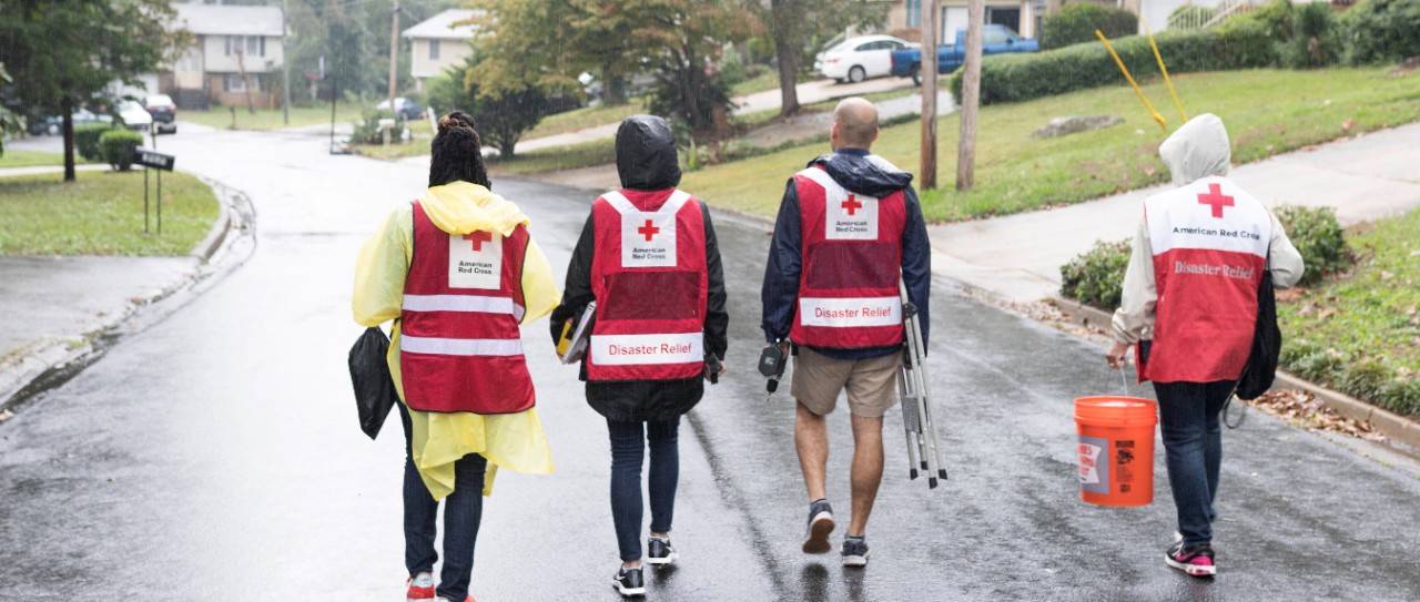 Volunteers walking with supplies