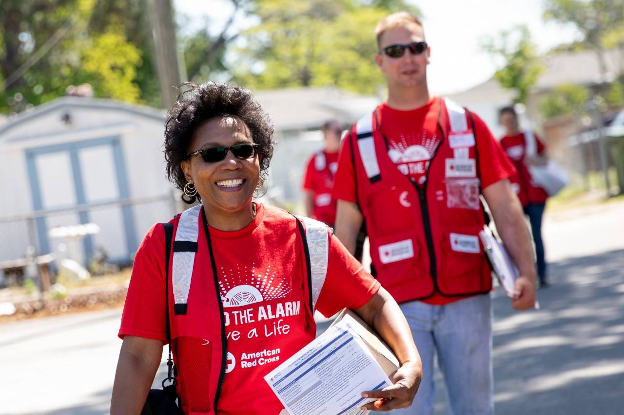 April 28, 2018. Wilmington, North Carolina.Smoke alarm installations at the Sound the Alarm event.Pictured: American Red Cross volunteers Carol Schwarzenbach and Jonathan FehrAmerican Red Cross volunteers Carol Schwarzenbach, Jonathan Fehr and their team go door-to-door in Wilmington, North Carolina during an event called  "Sound the Alarm." Teams of Red Cross volunteers fan out into local neighborhoods across the country, offering to install free smoke alarms in any home that needs them. As part of the installation they also teach families about fire prevention, and help them design escape plans, so they can practice how to get out of the building quickly in the event of a fire.Photo by Adam Jennings for the American Red Cross.