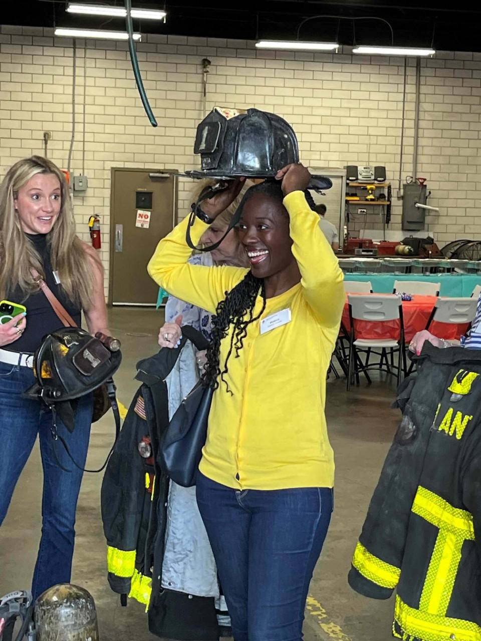 Melody Smalls tries on an Atlanta firefighter's helmet 