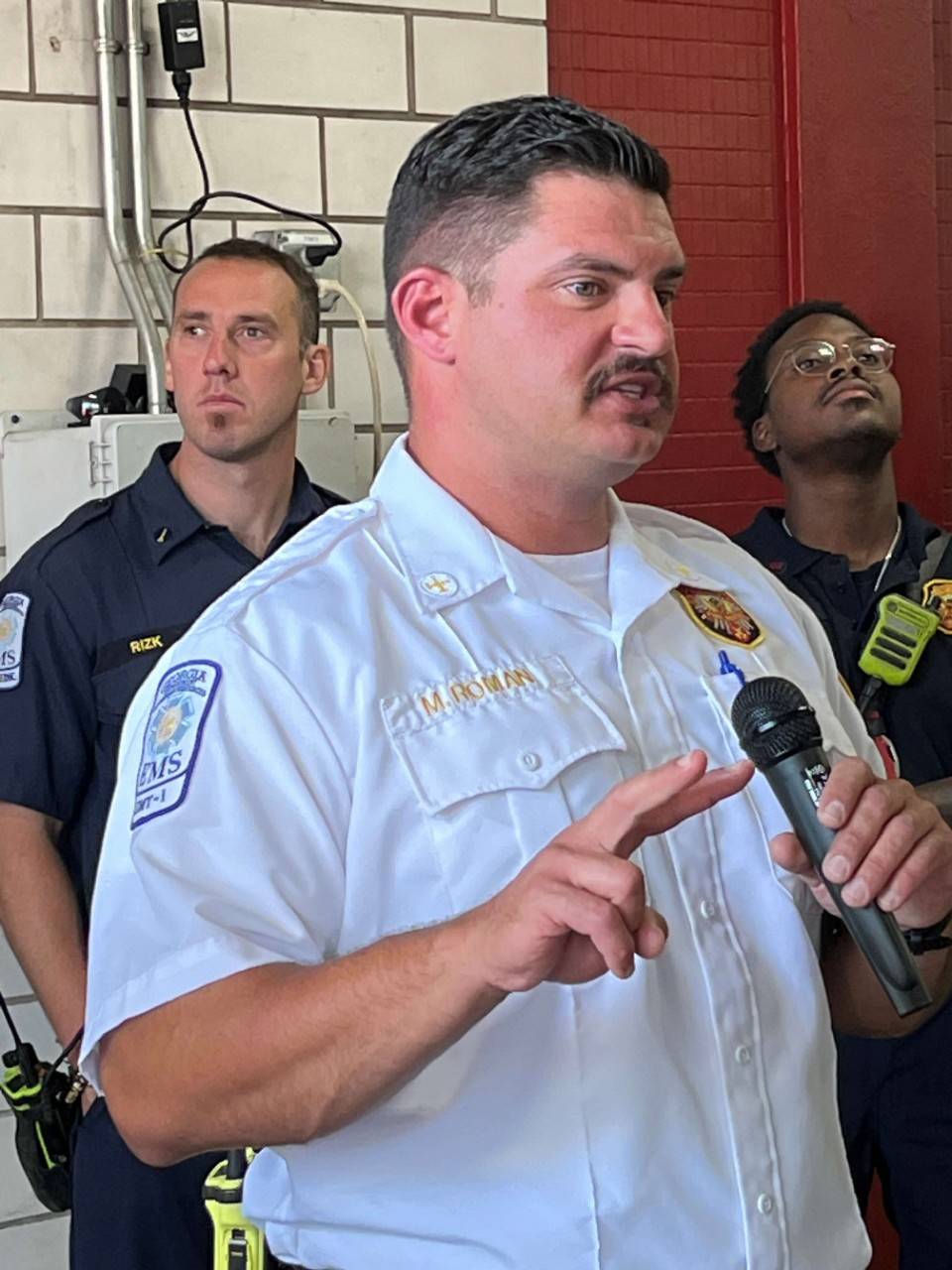 Battalion Chief Michael Roman speaks to volunteers