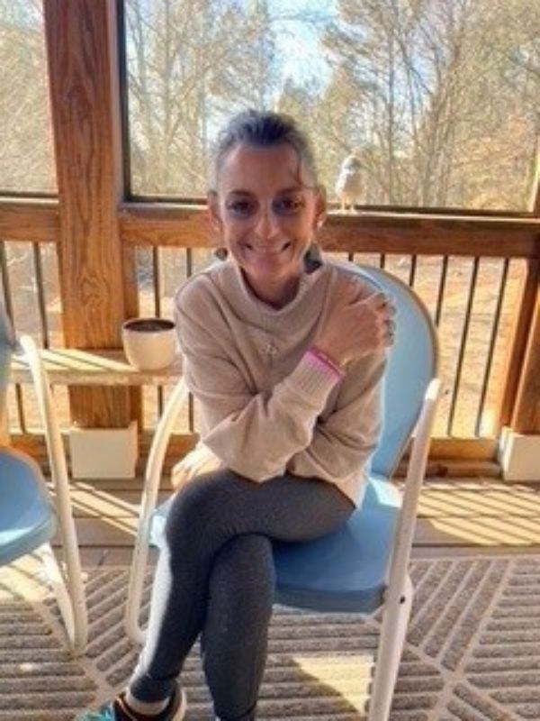 Woman in chair on screened in porch