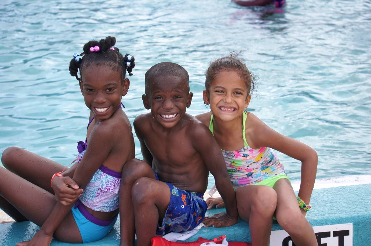 July 6, 2015. Brevard County Parks and Recreation, Florida. Ta'Mya Boyd, 8, Jeremiah Vildor, 6, and Brianna Deranleau  participate in swim lessons during summer camp as part of the Red Cross Centennial Campaign.  Photo by Connie Harvey/American Red Cross