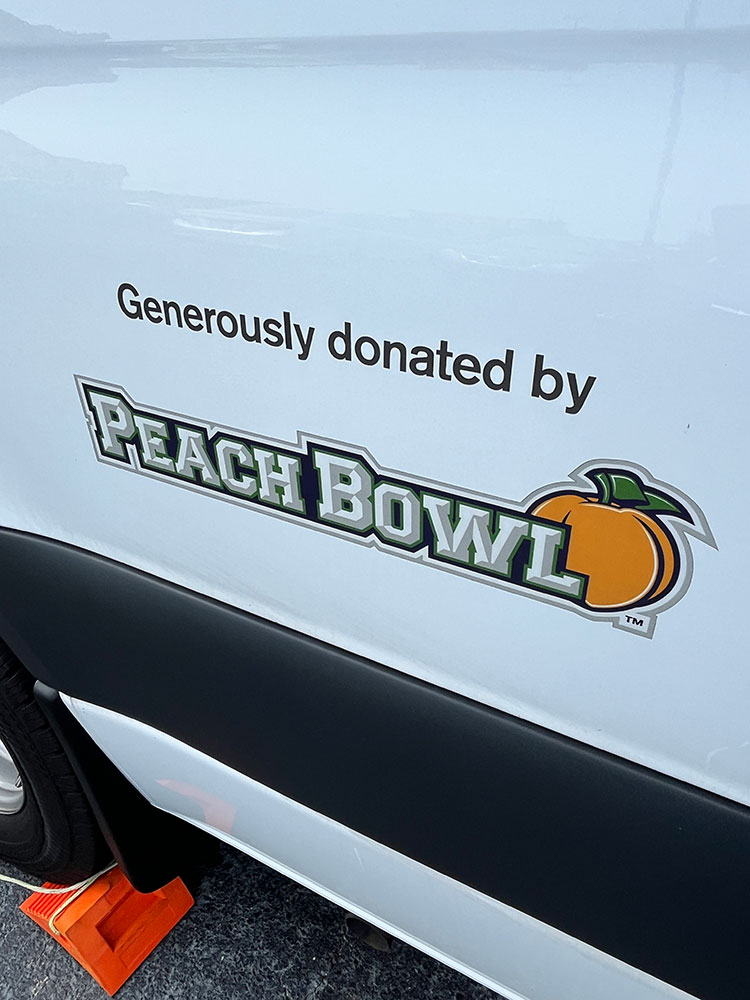 peach bowl sticker on the side of a Red Cross van.