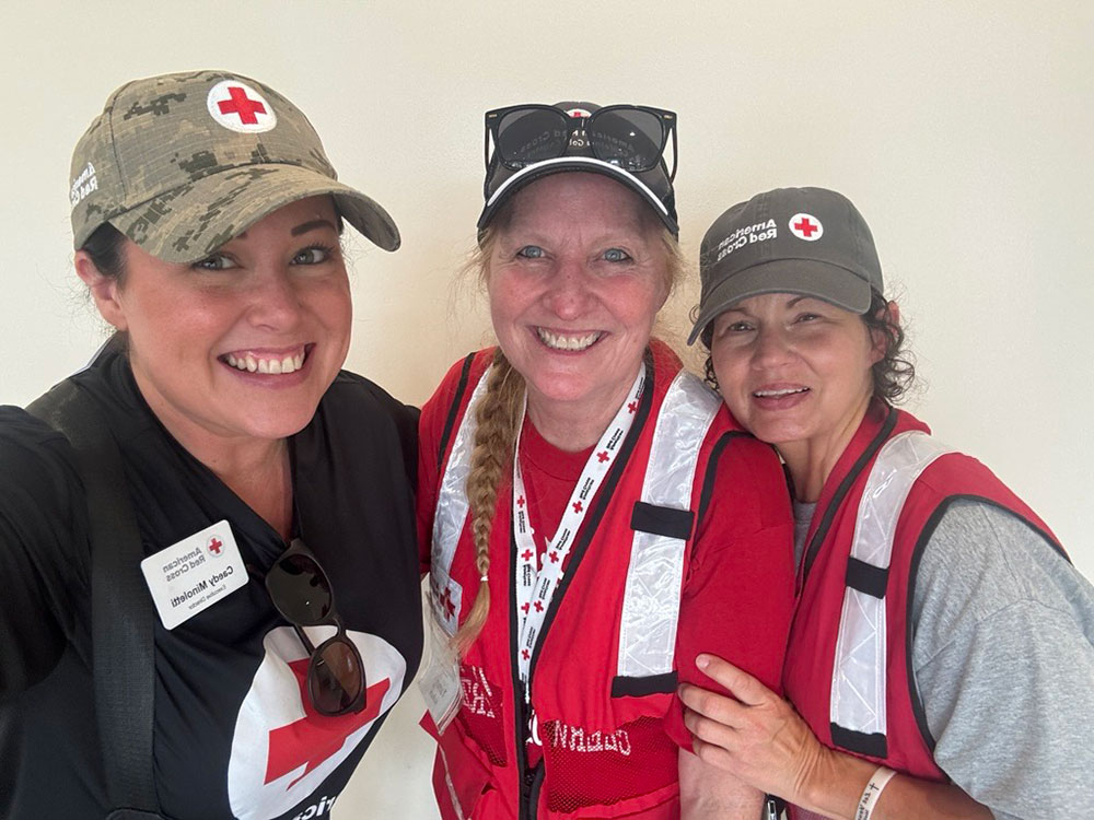 Caedy Minoletti and two Red Cross volunteers smiling for picture.